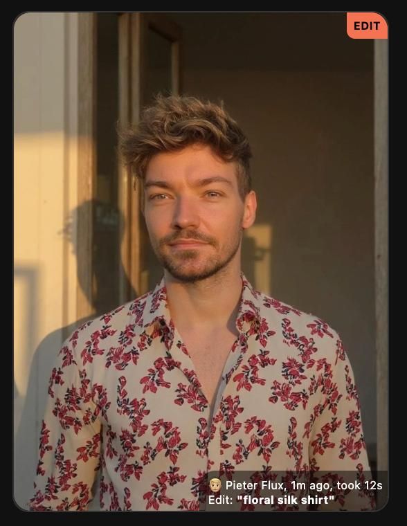A man stands in a sunlit doorway wearing a floral silk shirt.