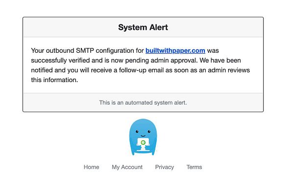 The image displays a system alert regarding SMTP configuration verification.