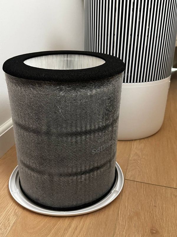 Close-up photo of a dirty air filter covered with dust and debris.