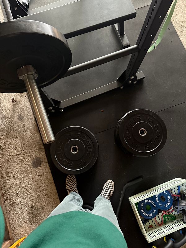 A view from above of a home gym setup featuring weights and workout equipment.