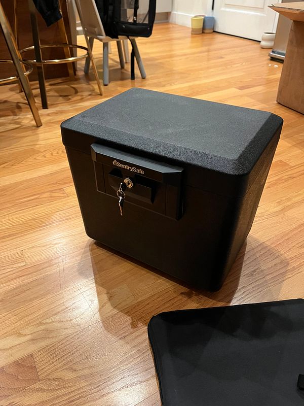 Interior of a wooden fireproof safe filled with organized important documents and folders.