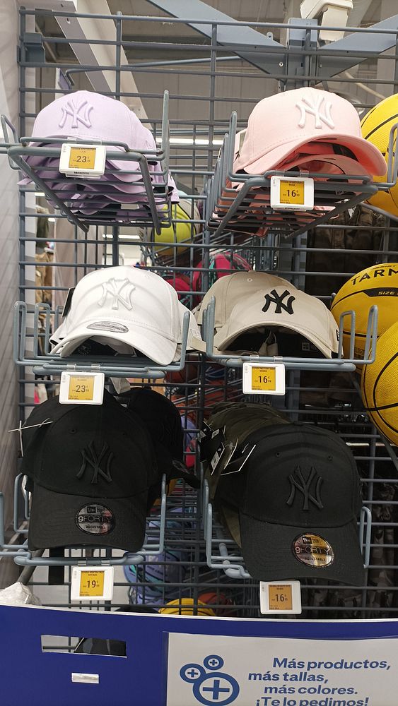 A display of various New York Yankees caps in different colors and prices.