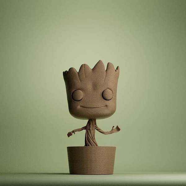 A 3D printed figure of a character resembling a tree-like creature stands on a simple base.
