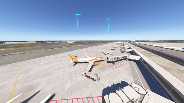 A view of an airport tarmac with multiple aircraft and terminal gates.