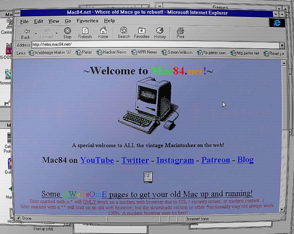 Vintage computer and related vintage technology items arranged on a wooden surface.