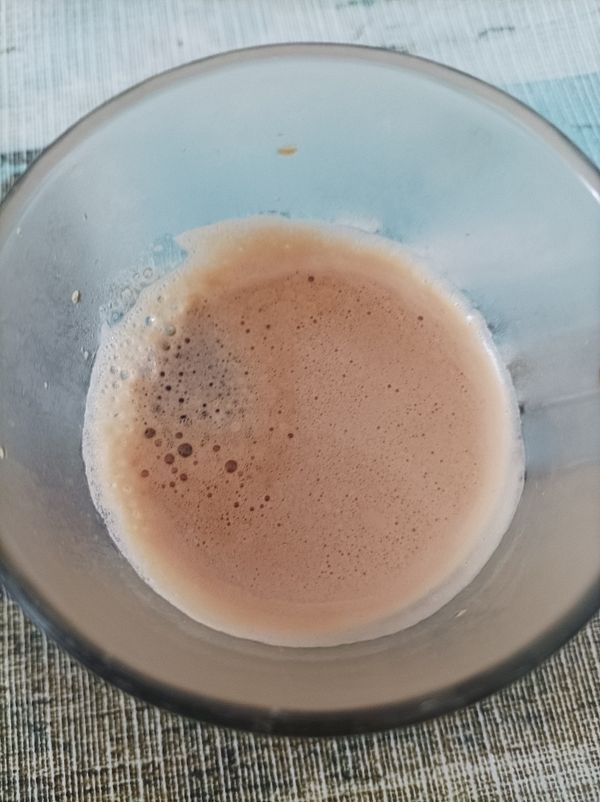 A close-up view of a glass containing espresso.