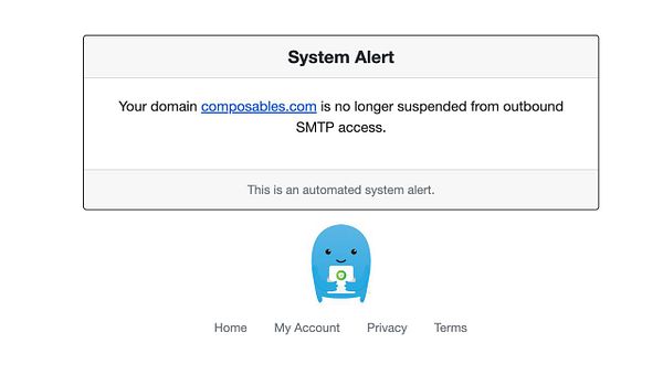 A system alert notification confirming the unblocking of a domain's SMTP access.