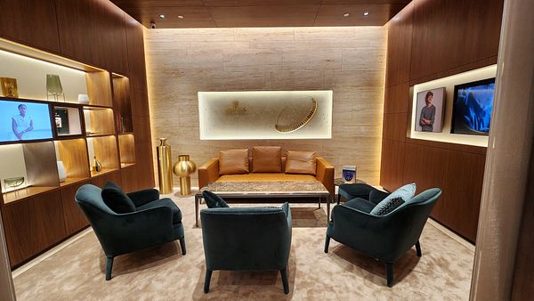 A luxurious interior of a Rolex boutique featuring elegant seating and decorative elements.