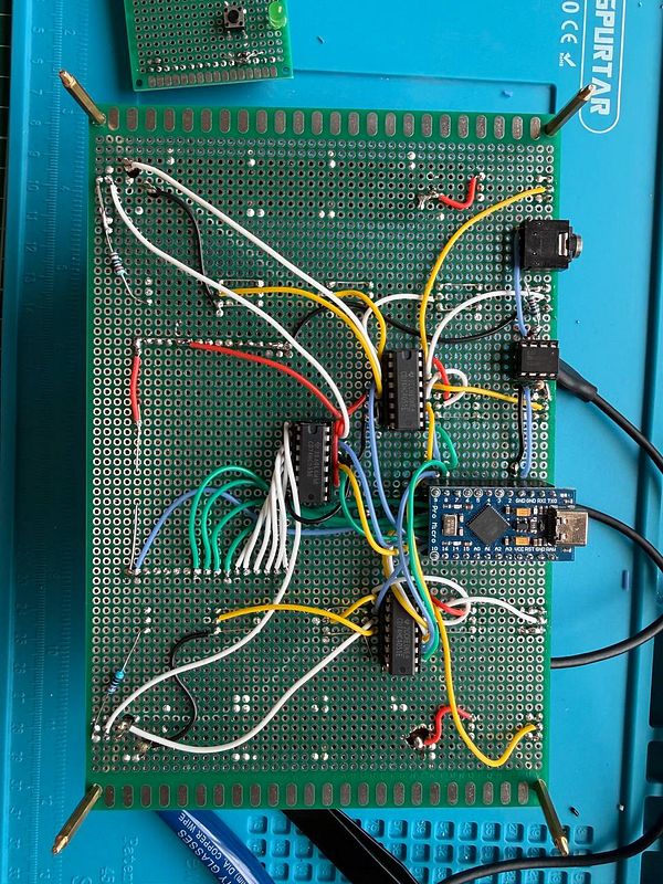 Top view of a midi controller prototype with six green-lit rotary encoders and a display.
