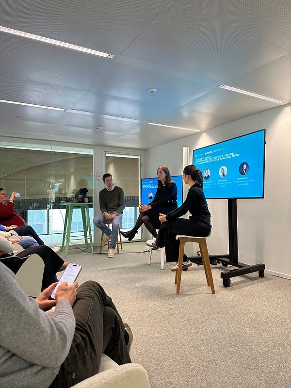 A panel discussion taking place at StationF with three speakers and an audience.