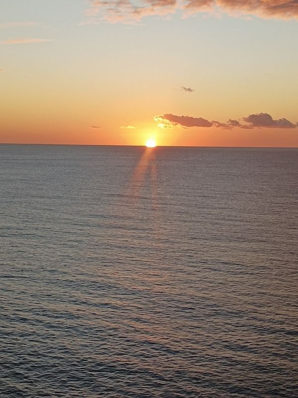 A stunning sunset over the ocean with vibrant colors.