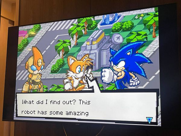 A scene from a retro video game featuring Sonic the Hedgehog and Tails discussing a robot.