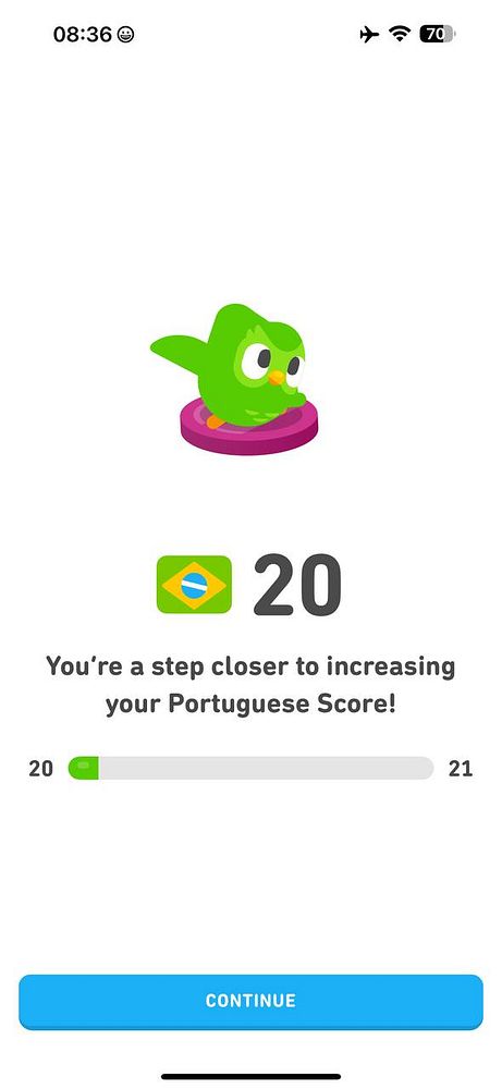 A progress screen from a language learning app showing a character and a score update for learning Portuguese.