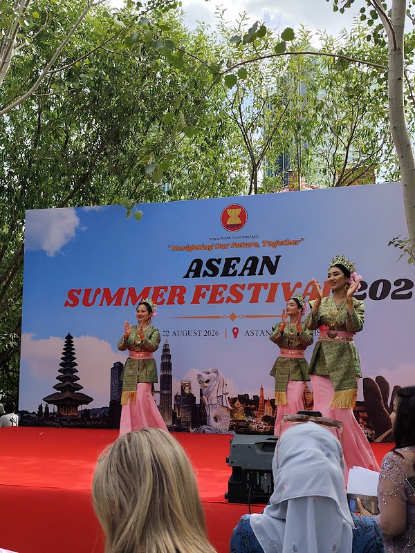 A vibrant scene of the ASEAN Summer Festival in Astana featuring cultural performances and decorations.