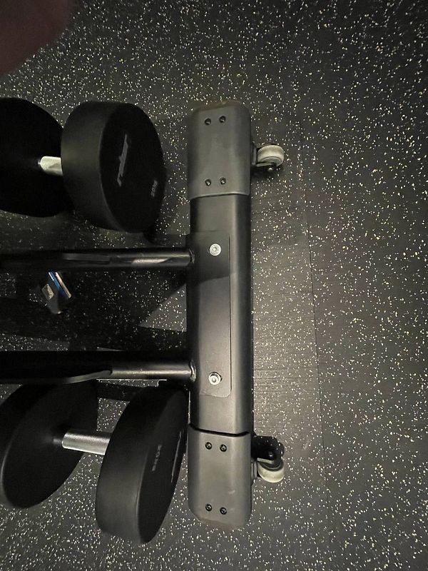 A close-up view of a gym equipment component with weights.
