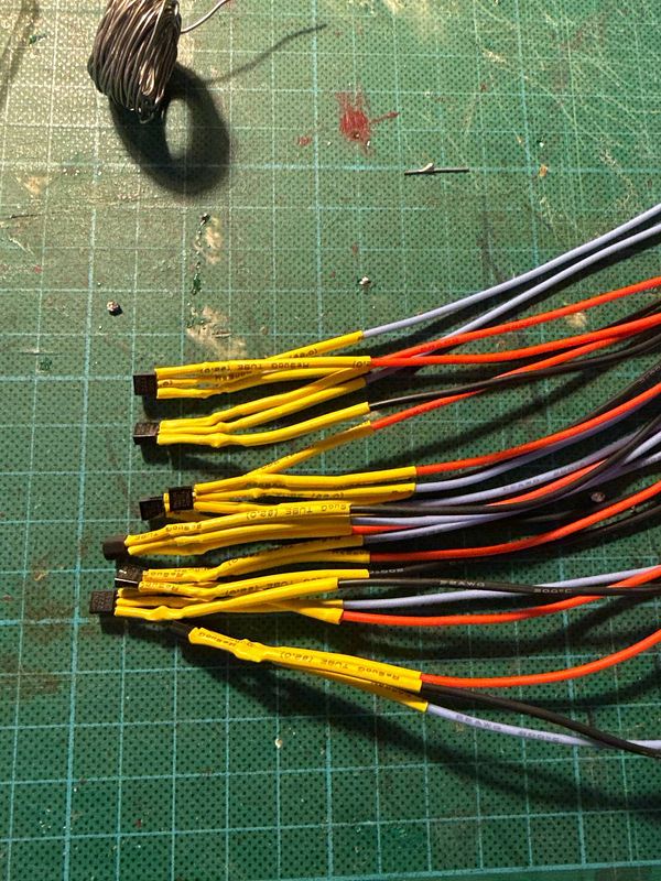 A collection of soldered sensor wires arranged on a work surface.