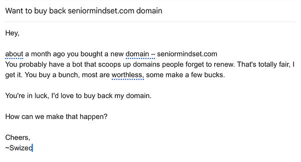 Portrait of a smiling bald man with a beard wearing a blue fleece jacket and a gray knit cap against a neutral background.