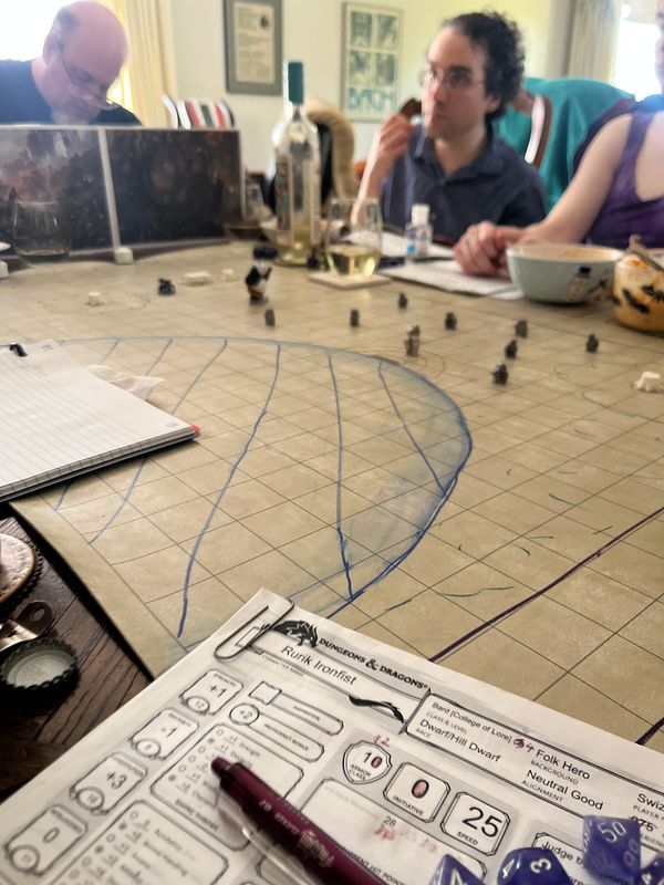 A tabletop gaming scene featuring players engaged in a Dungeons & Dragons session.
