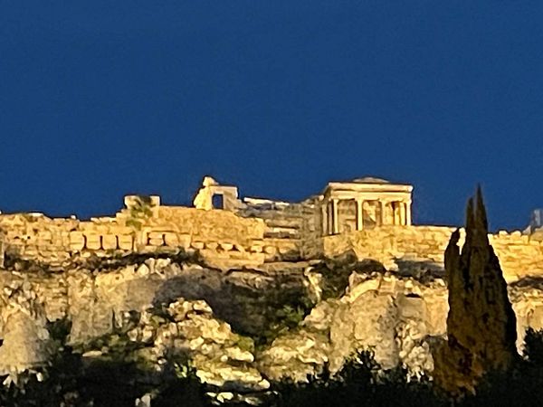 A historic structure illuminated at night against a dark blue sky.