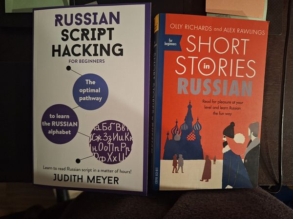 Two Russian language books are displayed side by side on a table.