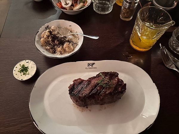 A beautifully presented steak dinner at a restaurant.