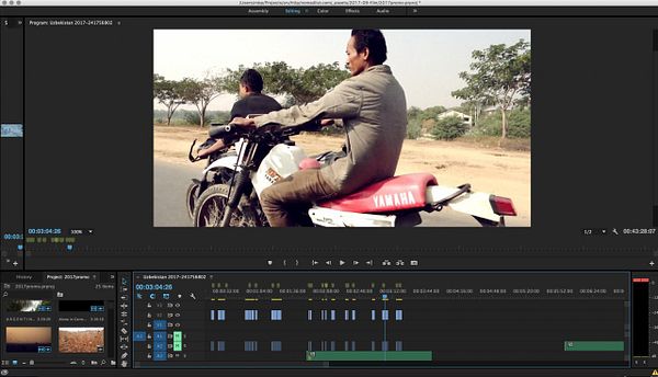 The image displays a video editing interface featuring a scene of a man riding a motorcycle.