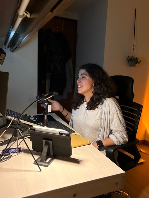 A woman is engaged in a virtual talk about AI tools at her desk.