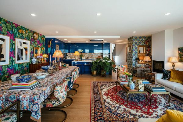 A vibrant and stylish interior space featuring a dining area and living room with eclectic decor.