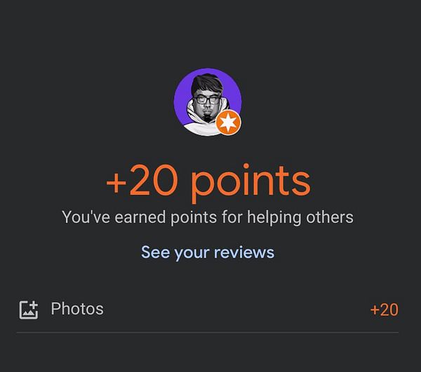 An architectural photo of a modern building with wooden paneling and a glass facade under a blue sky.