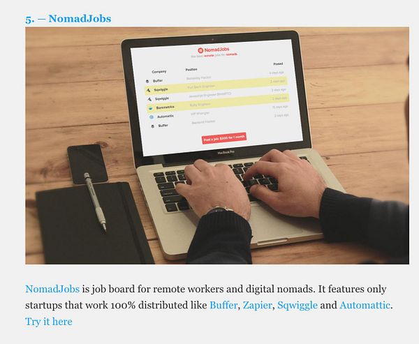 A person is using a MacBook Pro to browse job listings on the NomadJobs website.