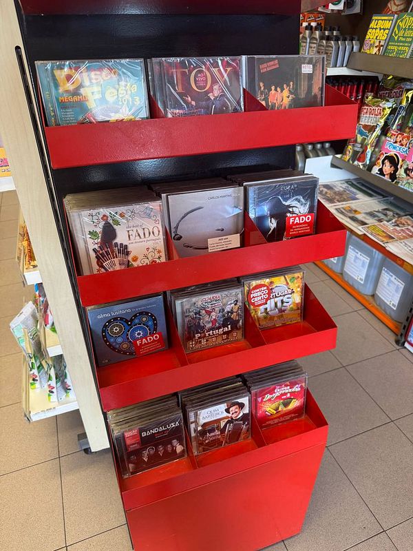 A display rack filled with various music CDs in a store.