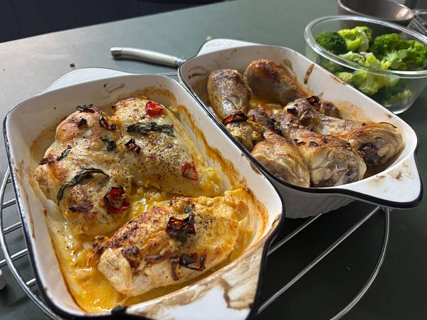 Oven-baked peri peri chicken is presented alongside a bowl of broccoli.