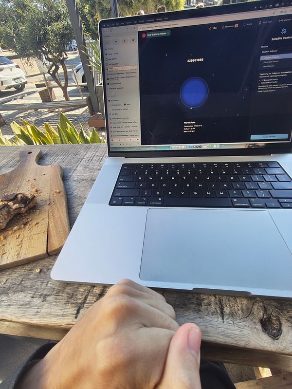 A person is preparing to leave for Switzerland while working on a laptop outdoors, accompanied by a snack.