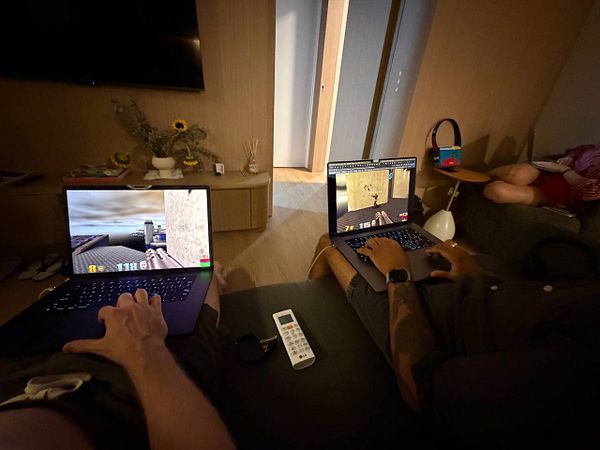 Anime-style illustration of two characters in vibrant outfits with a cityscape background.