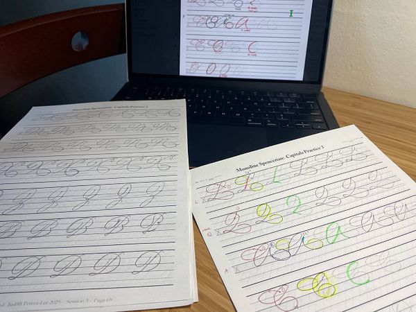The image features calligraphy homework sheets alongside a laptop displaying additional practice material.