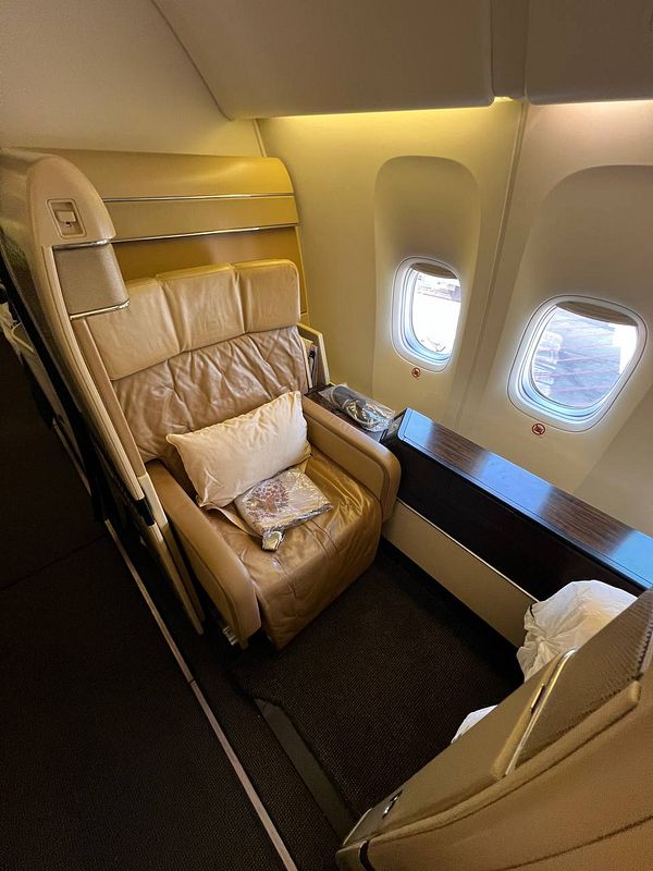 A luxurious airplane seat in a first-class cabin.