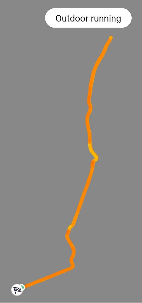 Photograph of a city street with tram lines, outdoor seating, and flowering trees.