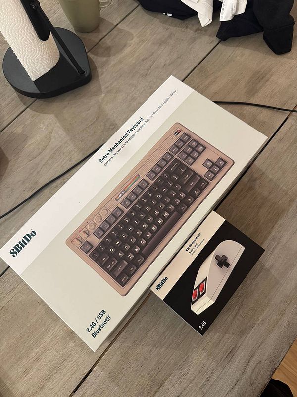 The image features a retro-style keyboard and mouse packaged for a physical prototype.