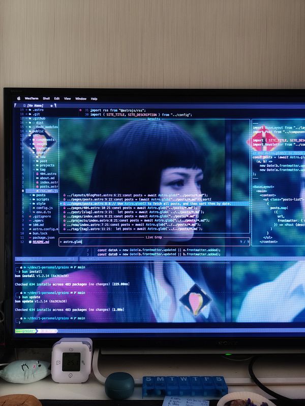 A computer screen displays code alongside a blurred image of a person.