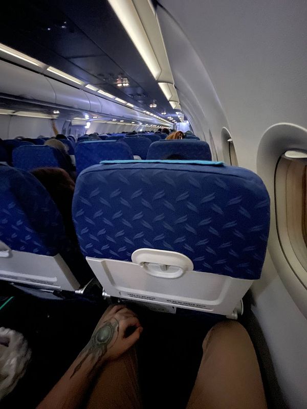 Interior view of an airplane cabin with passengers seated.