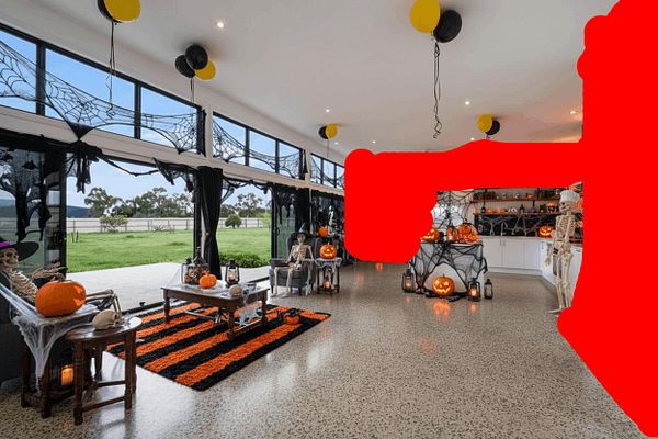 A festive Halloween-themed interior featuring decorations, skeletons, and pumpkins.