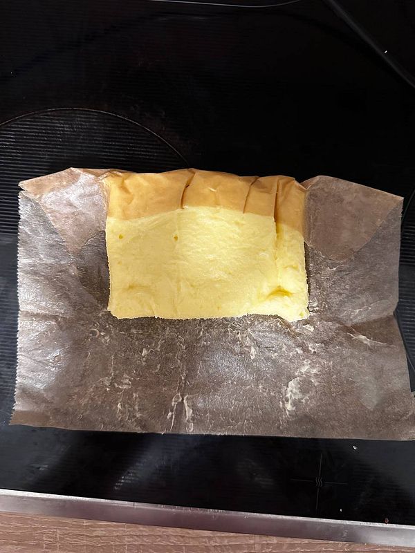 A block of homemade butter is displayed on a piece of parchment paper.