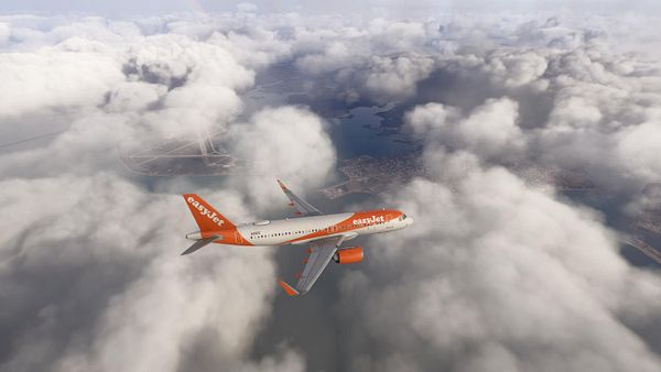 A photograph of a white turboprop airplane on the ground at Lisbon Airport during stormy weather with overcast skies and raindrops on the camera lens.