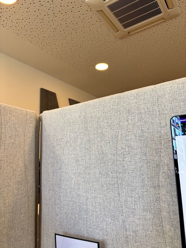 The image captures a workspace with cubicle partitions and a ceiling view.