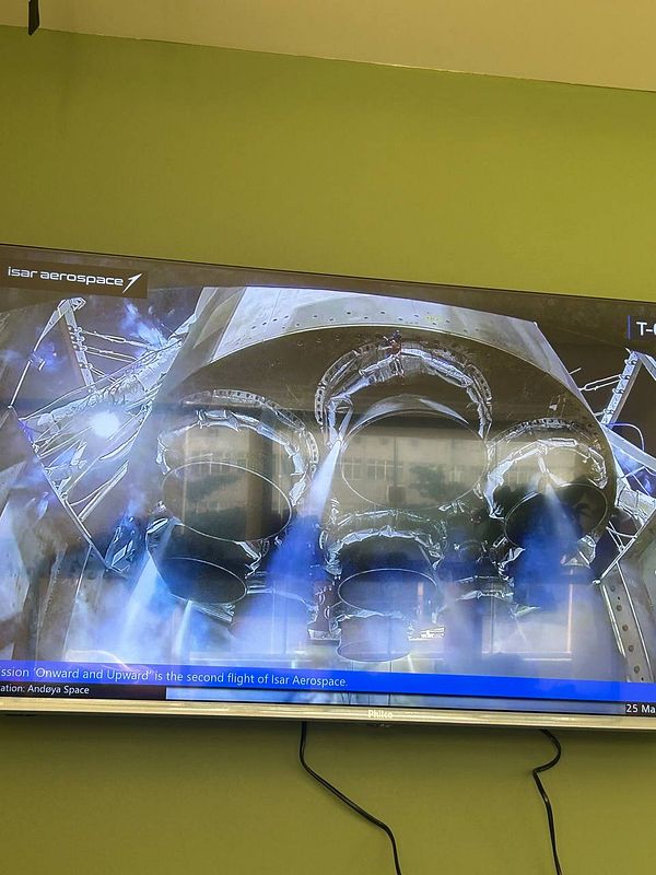 Rocket launch at an Isar Aerospace facility surrounded by snowy mountains.