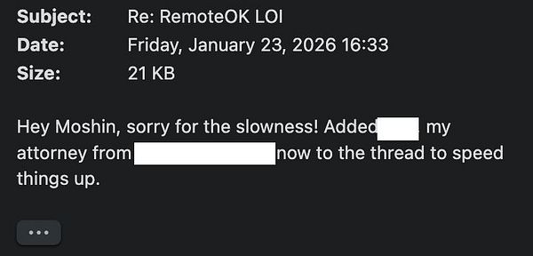 Email conversation on a laptop screen about adding a lawyer to an M&A remote team email thread.