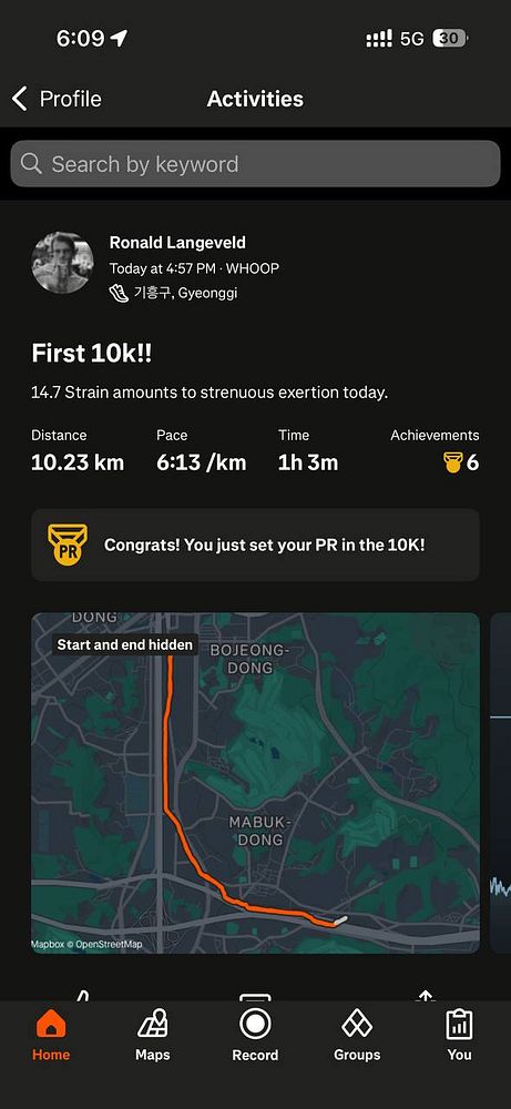 A fitness tracking app interface displaying a user's first 10km run details.