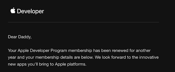 Close-up image of a yellow apple with a brownish spot on its skin, resting on an orange surface.