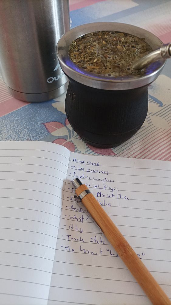 A vibrant workspace setup featuring a laptop, smartphone, and colorful desk items on a graphic-covered surface.