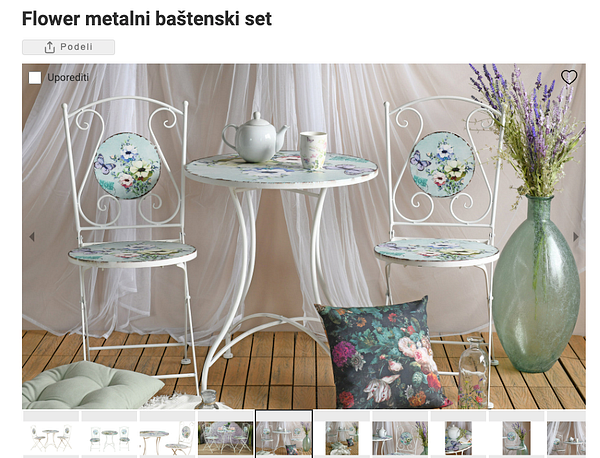 A charming metal garden set featuring floral designs, perfect for a balcony.
